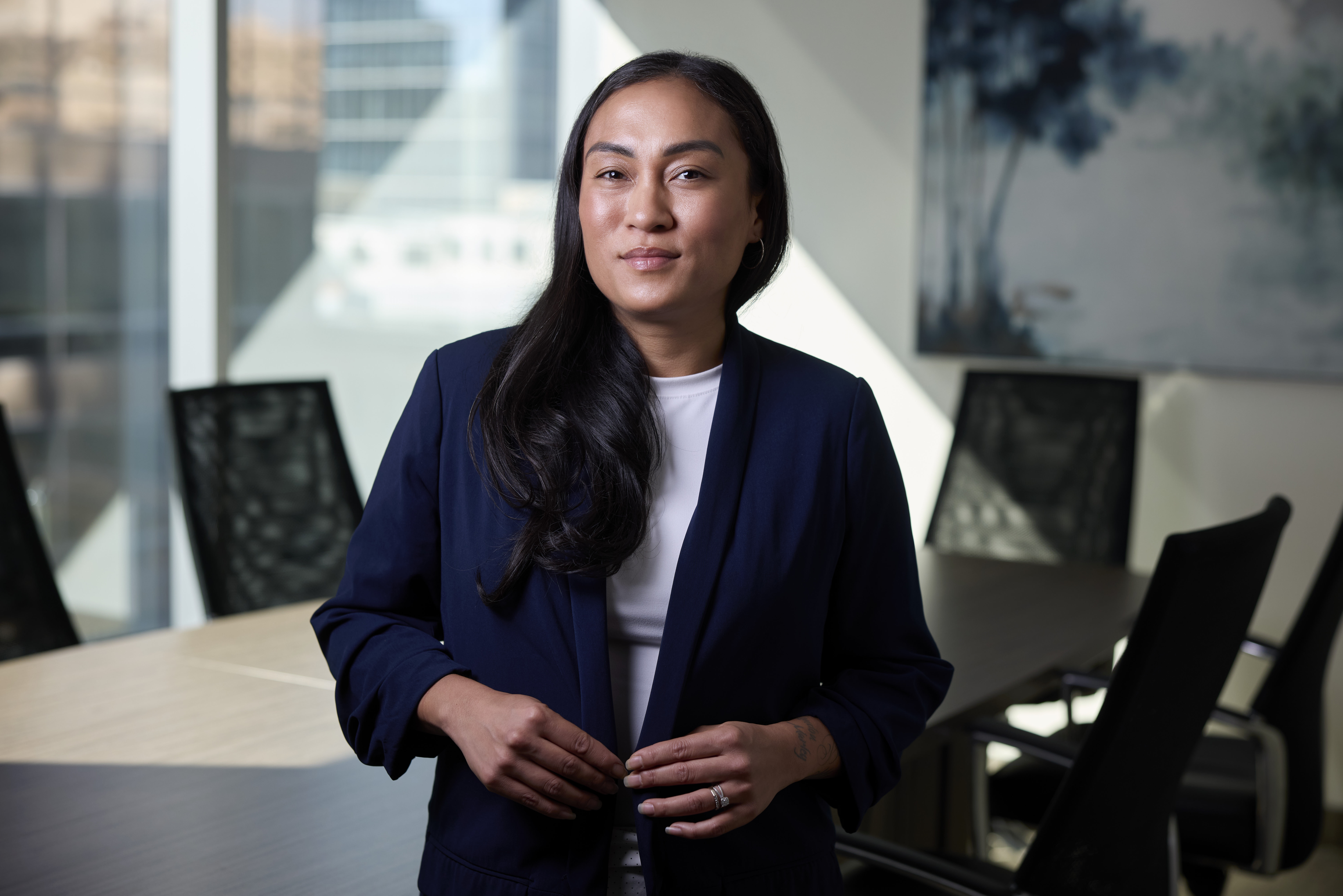 An image of Mitzi Verzola Client Operations Analyst in the boardroom at Our Family Office